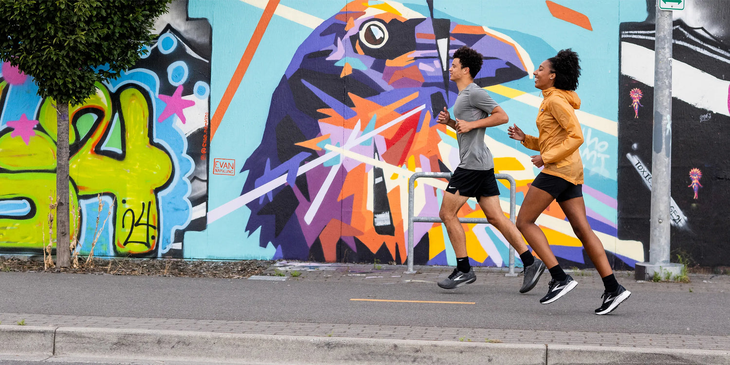 Man and woman running with Superfeet active insoles.